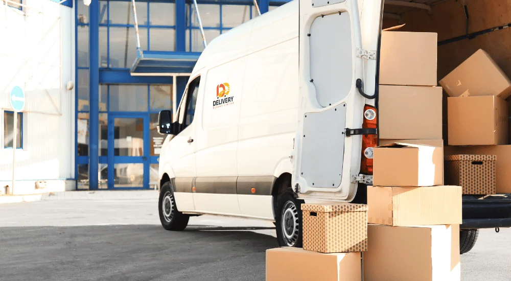 A delivery van in Birmingham delivering packages to a local business, showcasing efficient product delivery services.