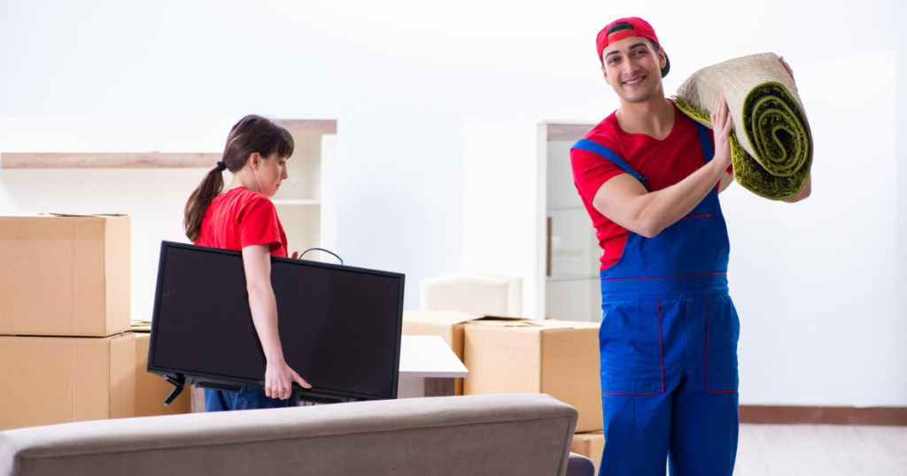 Office relocation team carrying office equipment and furniture during a move.